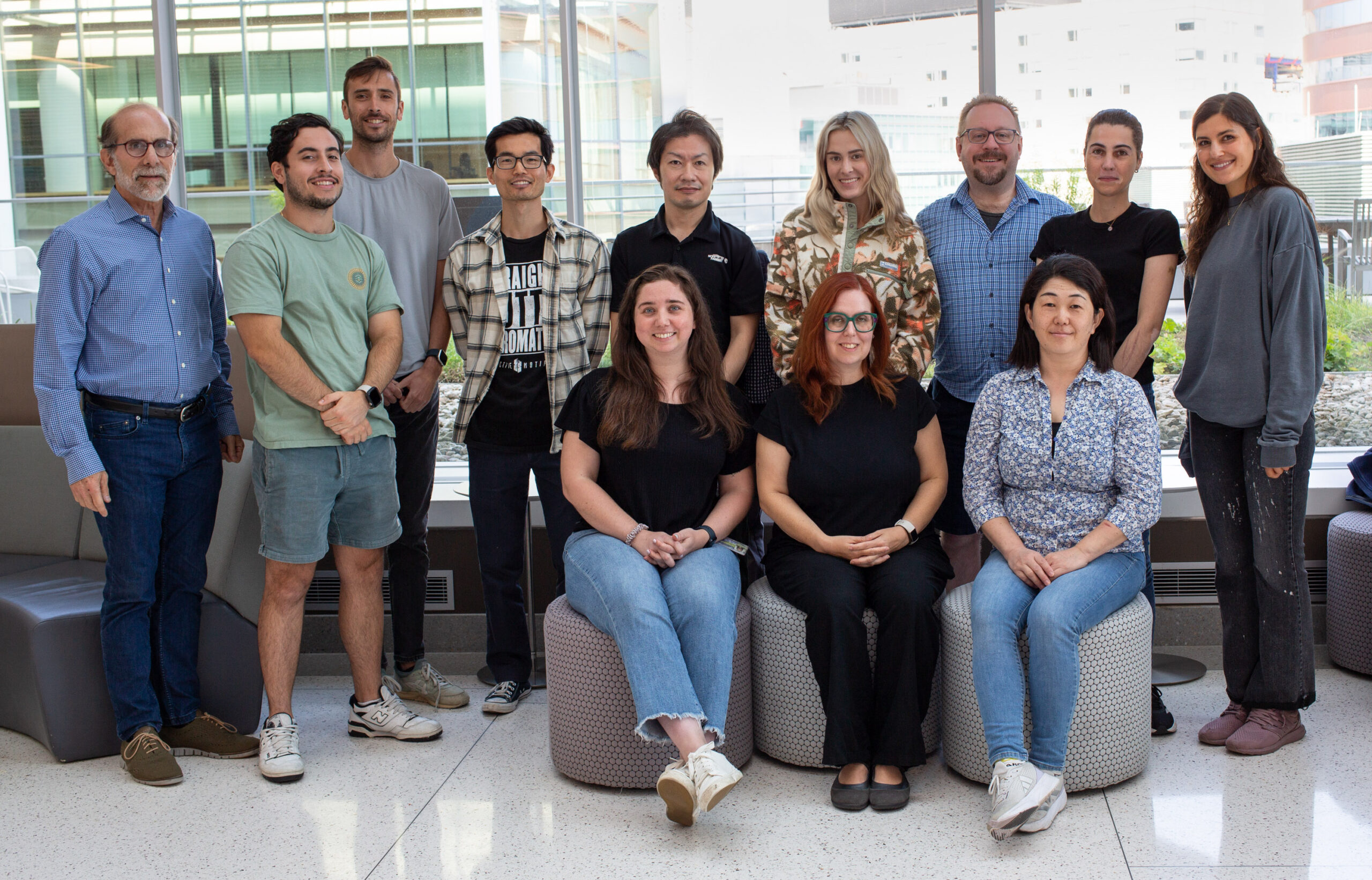 Twelve lab members posing for lab website group photo